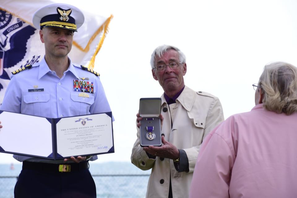 Ric Marion, nephew of USS Leopold crew member Glyone Mahaffy, is presented the Purple Heart Medal on behalf of the U.S. Coast Guard during a ceremony at Fort Gratiot Lighthouse in Fort Gratiot, on Monday, May 23, 2022. Mahaffy served aboard the USS Leopold during World War II and was one of only 28 survivors after a torpedo from a German U-Boat struck the hull of the shop, splitting it in two on the night of March 9, 1944.