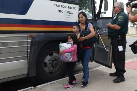 An undocumented immigrant family is released from detention at a bus depot in McAllen, Texas, June 22, 2018. REUTERS/Loren Elliott