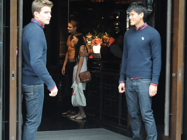 More men-candies, one of them shirtless, greet shoppers at the store’s doorstep. (Yahoo! photo/ Kai Fong)