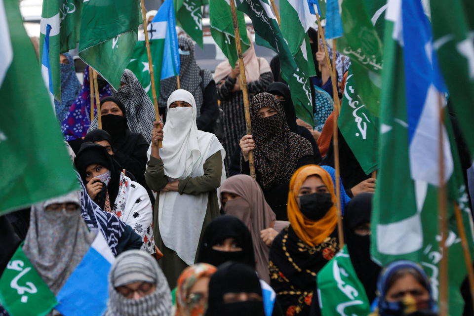 Women in hijabs hold flags as they take part in a protest against the recent hijab ban in some colleges in the Indian state of Karnataka, in Karachi, Pakistan February 10, 2022. REUTERS/Akhtar Soomro     TPX IMAGES OF THE DAY