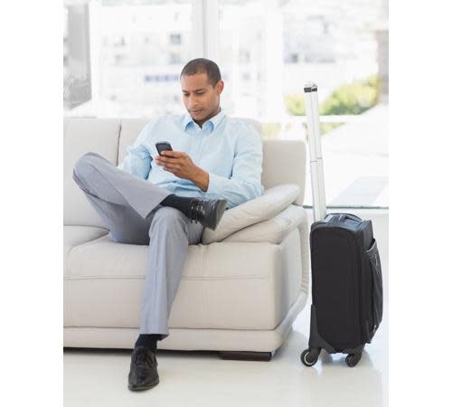 Man in suit with carry-on bag