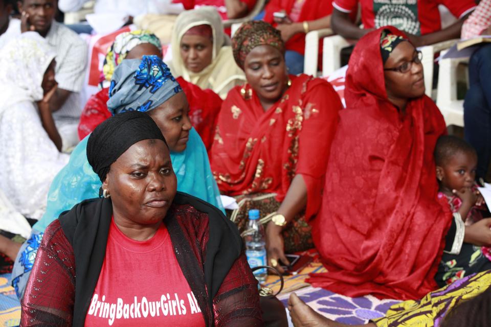 Women attend a rally calling on the Government to rescue the school girls kidnapped from the Chibok Government secondary school, in Abuja, Nigeria, Saturday May 10, 2014. The president of Nigeria for weeks refused international help to search for more than 300 girls abducted from a school by Islamic extremists, one in a series of missteps that have led to growing international outrage against the government. The waiting has left parents in agony, especially since they fear some of their daughters have been forced into marriage with their abductors for a nominal bride price of $12. Boko Haram leader Abubakar Shekau called the girls slaves in a video this week and vowed to sell them. "For a good 11 days, our daughters were sitting in one place," said Enoch Mark, the anguished father of two girls abducted from the Chibok Government Girls Secondary School. "They camped them near Chibok, not more than 30 kilometers, and no help in hand. For a good 11 days." (AP Photo/Sunday Alamba)