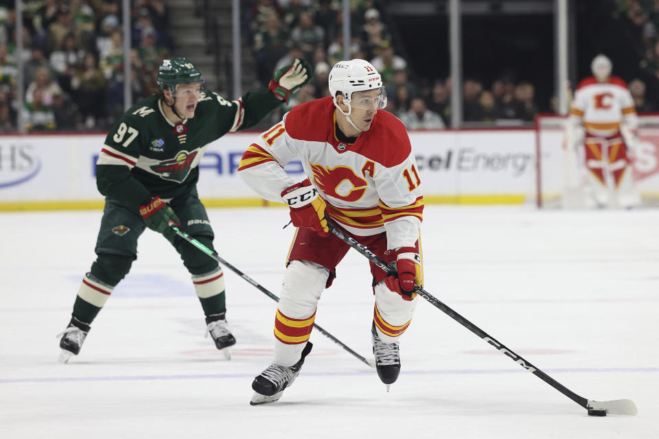 Calgary Flames center Mikael Backlund (11) handles the puck during the second period of the team's NHL hockey game against the Minnesota Wild on Tuesday, March 7, 2023, in St. Paul, Minn. (AP Photo/Stacy Bengs)