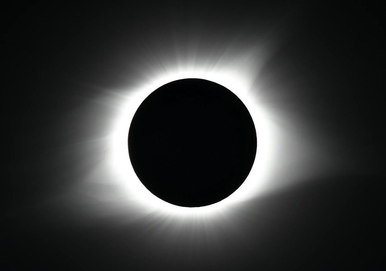 Solar eclipses happen because of a few factors, including the Moon's size and distance from the Sun. <a href="https://newsroom.ap.org/detail/EclipseKentucky/8b202fc6981149ebb1c59158d49e348d/photo?Query=eclipse&mediaType=photo&sortBy=&dateRange=Anytime&totalCount=478&digitizationType=Digitized&currentItemNo=7&vs=true&vs=true" rel="nofollow noopener" target="_blank" data-ylk="slk:AP Photo/Timothy D. Easley;elm:context_link;itc:0;sec:content-canvas" class="link ">AP Photo/Timothy D. Easley</a>