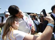 Novak Djokovic of Serbia takes a selfie with a fan after a practice session at the Wimbledon Tennis Championships in London, July 9, 2015. REUTERS/Suzanne Plunkett