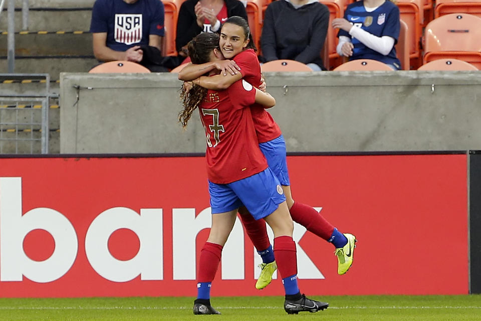 Costa Rica forward Maria Salas (17) lifts forward Melissa Herrera, right, after Herrera's score against Panama during the first half of a women's Olympic qualifying soccer match Tuesday, Jan. 28, 2020, in Houston. (AP Photo/Michael Wyke)