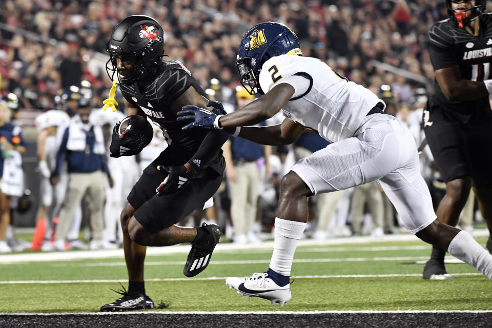 Murray State defensive back Zayteak McGhee (2) attempts to stop Louisville wide receiver Ahmari Huggins-Bruce (9), who scored at touchdown during the second half of an NCAA college football game in Louisville, Ky., Thursday, Sept. 7, 2023. (AP Photo/Timothy D. Easley)