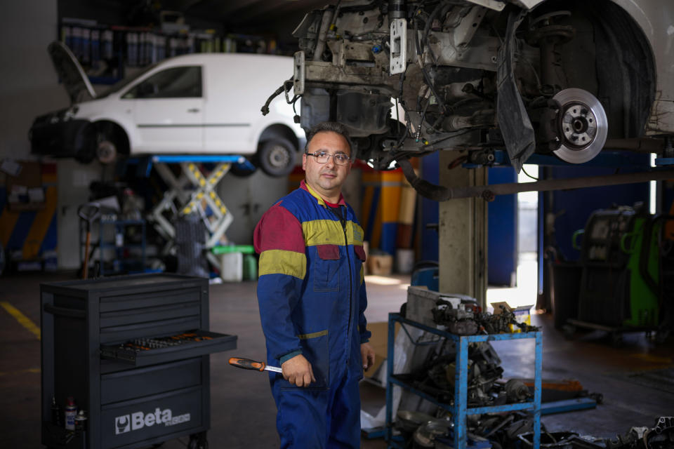 Francesco Del Papa poses in his car repair shop in Castelnuovo Vomano near Teramo in central Italy, Sunday, June 4, 2023. (AP Photo/Domenico Stinellis)