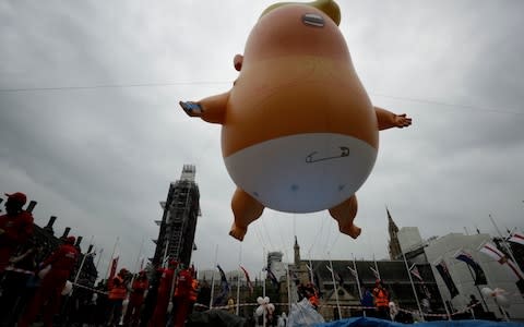 The Trump baby blimp is inflated in Parliament Square  - Credit: Matt Dunham/AP