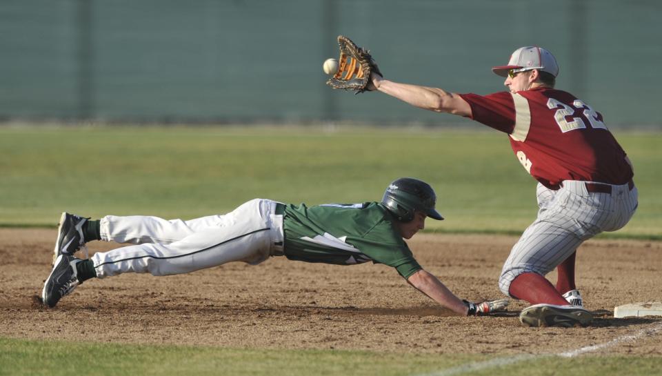 El Diamante's Patrick Jones (17) slides safely back to first as the ball arrives to Clovis West's Tyler Ferguson (22) on Wednesday, March 9, 2011.
