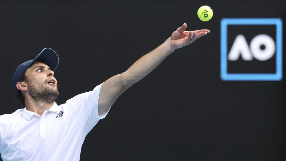 Russia's Aslan Karatsev serves to Bulgaria's Grigor Dimitrov during their quarterfinal match at the Australian Open tennis championship in Melbourne, Australia, Tuesday, Feb. 16, 2021.(AP Photo/Hamish Blair)