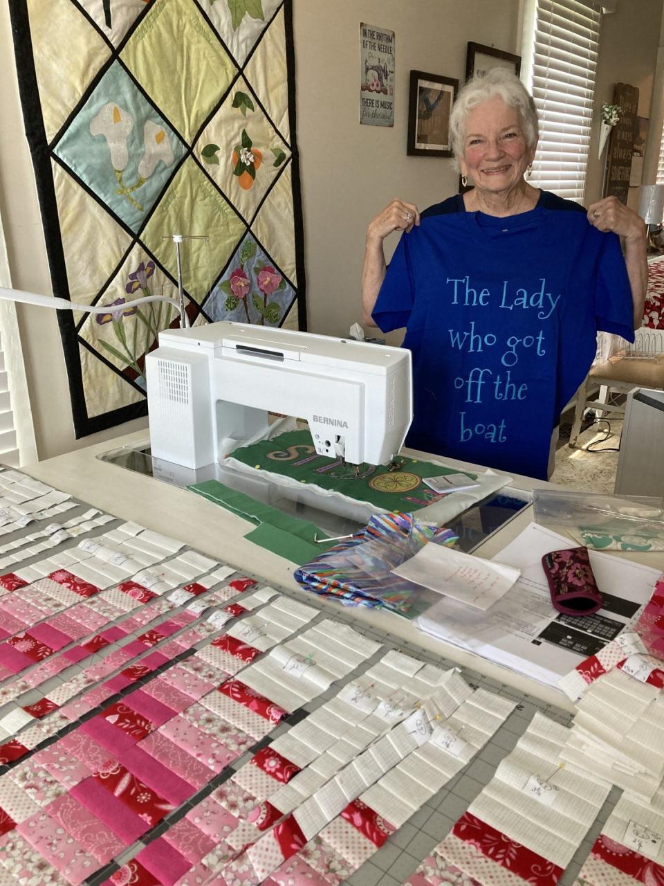 Jackie Calvert with her “celebrity” T-shirt, posing in her sewing studio at one of the homes she purchased near downtown Henderson after a riverboat cruise stop inspired her to move from Florida.