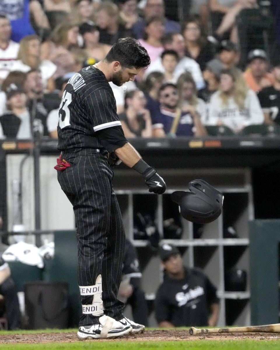 Chicago White Sox's Andrew Benintendi slams his helmet down after striking out off a pitch from Milwaukee Brewers relief pitcher Joel Payamps, with two onboard, to end the eighth inning of a baseball game Friday, Aug. 11, 2023, in Chicago. (AP Photo/Charles Rex Arbogast)