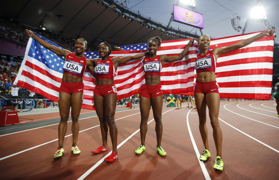 United States' women's 4 x100-metre relay team members, from left, Carmelita Jeter, Bianca Knight, Tianna Madison and Allyson Felix, celebrate their gold medal win during the athletics in the Olympic Stadium at the 2012 Summer Olympics, London, Friday, Aug. 10, 2012. The United States relay team set a new world record with a time of 40.82 seconds (AP Photo/Matt Dunham)