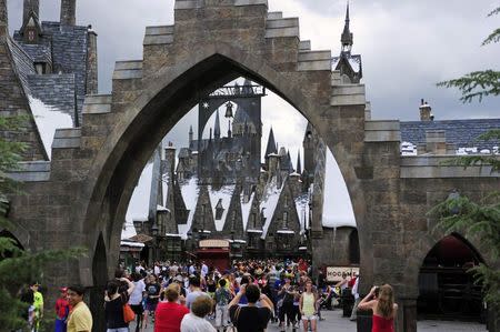 Guests walk in and out of Hogsmeade Village during a media preview for The Wizarding World of Harry Potter-Diagon Alley at the Universal Orlando Resort in Orlando, Florida June 19, 2014. REUTERS/David Manning