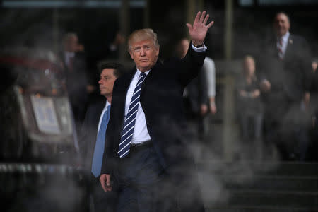 U.S. President Donald Trump waves as he leaves the Central Intelligence Agency (CIA) headquarters after delivering remarks during a visit in Langley, Virginia U.S., January 21, 2017. REUTERS/Carlos Barria