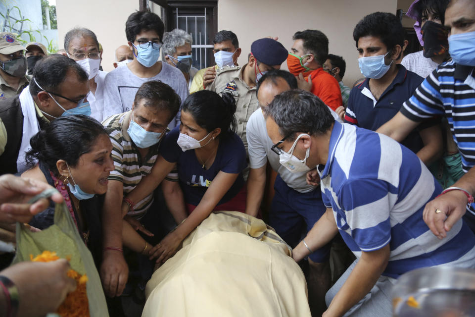 Relatives of Rakesh Pandita, a politician who was killed late Wednesday, mourns at his residence in Jammu, India, Thursday, June.3, 2021. Assailants fatally shot the politician belonging to India’s ruling party in disputed Kashmir, police said Thursday, blaming separatist rebels for the attack. The unidentified assailants fired at Pandita late Wednesday in the southern town of Tral, where he was visiting a friend, police said. He was declared dead in a hospital. (AP Photo/Channi Anand)