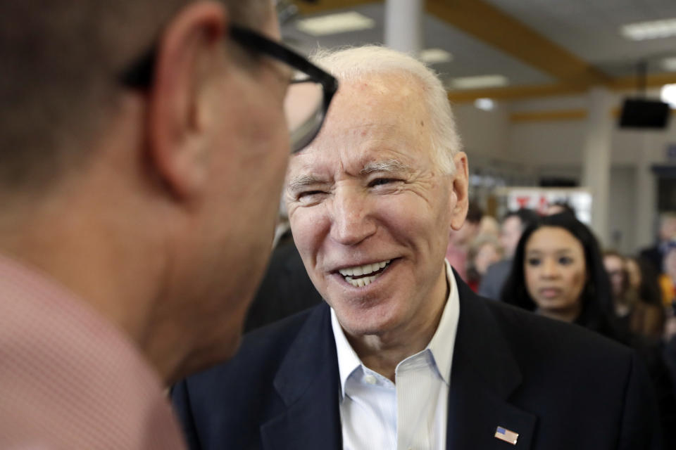 Democratic presidential candidate former Vice President Joe Biden, right, talks to a supporter during a campaign event Sunday, Feb. 2, 2020, in Dubuque, Iowa. (AP Photo/Marcio Jose Sanchez)