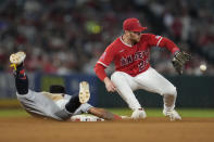Cleveland Guardians' Gabriel Arias, left, is safe at second on a double ahead of a throw to Los Angeles Angels second baseman Brandon Drury (23) during the sixth inning of a baseball game in Anaheim, Calif., Friday, Sept. 8, 2023. (AP Photo/Ashley Landis)
