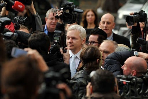 WikiLeaks founder Julian Assange (C) walks through a mass of media as he arrives at London's High Court. Assange has lost a bitter legal battle to block his extradition from Britain to Sweden to face questioning over allegations of rape and sexual assault