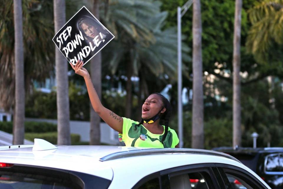 Jasmine Bell holds a sign from inside a vehicle as protesters march toward the home of Miami-Dade State Attorney Katherine Fernández Rundle in Coconut Grove demanding her to drop all charges against Black Lives Matter demonstrators, including more than 100 demonstrators who have been arrested in the 70 days since George Floyd’s death, Tuesday, August 11, 2020.