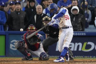 Los Angeles Dodgers' Mookie Betts hits an RBI double during the eighth inning in Game 3 of baseball's National League Championship Series against the Atlanta Braves Tuesday, Oct. 19, 2021, in Los Angeles. (AP Photo/Marcio Jose Sanchez)