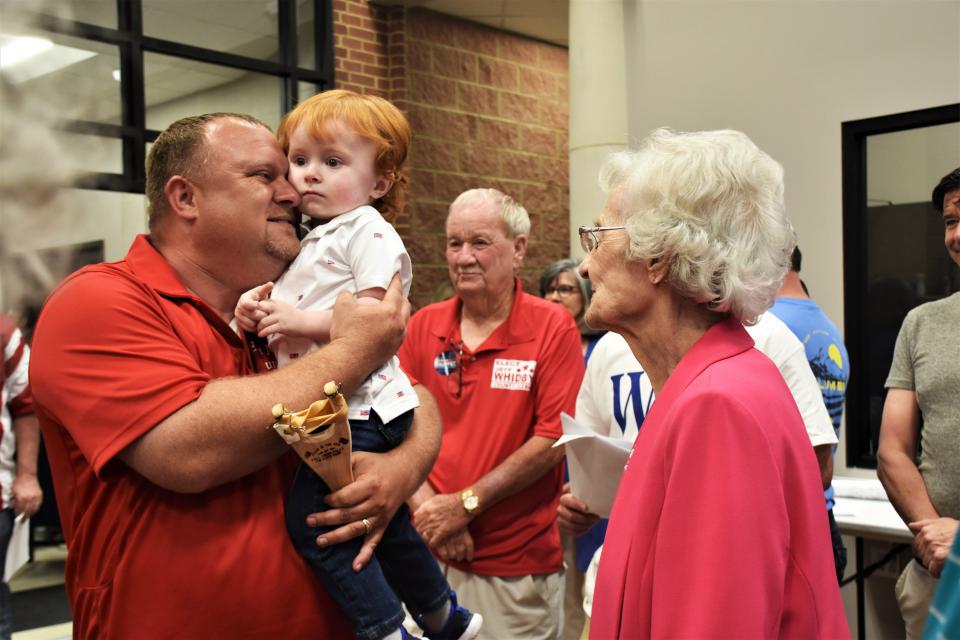 Williamson County Clerk Republican primary winner Jeff Whidby, accompanied by his grandmother and former County Clerk Elaine Anderson, hugs his son Braxton at the election commission office on May 3, 2022, in Franklin, Tenn.