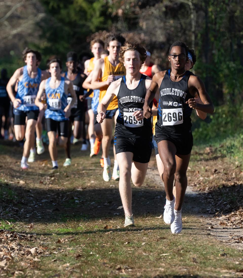 Middletown's Jonathan Drew (right) leads teammate Jonas Rush before Drew took first and Rush fourth in the DIAA Division I Boys Cross Country race on Nov. 12 at Killens Pond State Park. Drew earned the Vic Zwolak Award as the state's top boys runner.