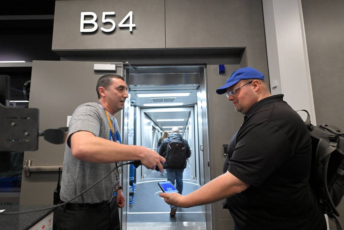 Southwest Airlines agent Kerry Weighill began boarding the first travelers to depart out of the new $1.5 billion single terminal at Kansas City International Airport opened to travelers Tuesday. The flight was heading to Chicago.