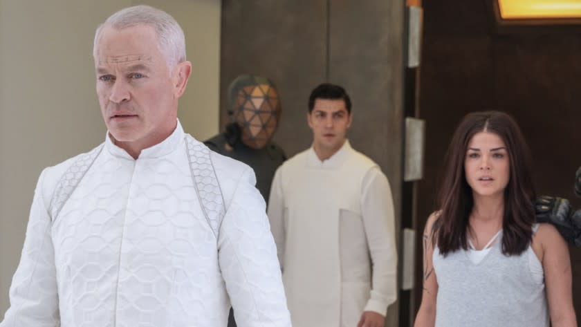 The 100 -- The CW TV Series, The 100 -- "Welcome to Bardo" -- Image Number: HU705A_0629r.jpg -- Pictured (L-R): Neal McDonough as Anders, Jason Diaz as Levitt and Marie Avgeropoulos as Octavia -- Photo: Colin Bentley/The CW -- 2020 The CW Network, LLC. All rights reserved. Neal McDonough, left, Jason Diaz and Marie Avgeropoulos in "The 100" on The CW.