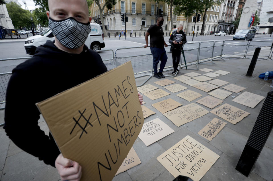 Posters with names of people that died during the COVID-19 pandemic are placed in front of the entrance to Downing Street in London, Wednesday, July 15, 2020. (AP Photo/Frank Augstein)