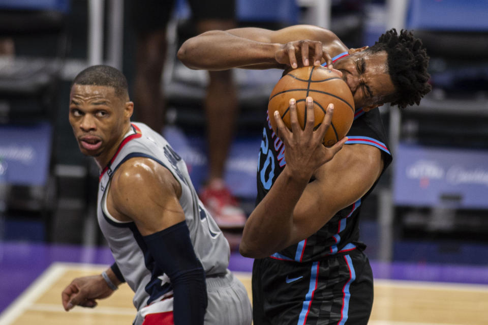 Sacramento Kings center Hassan Whiteside (20) reacts after getting fouled by Washington Wizards guard Russell Westbrook (4) during the second quarter of an NBA basketball game in Sacramento, Calif., Wednesday, April 14, 2021. (AP Photo/Hector Amezcua)