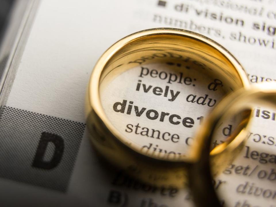 Divorce and separation concept. Two golden wedding rings. Dictionary definition.