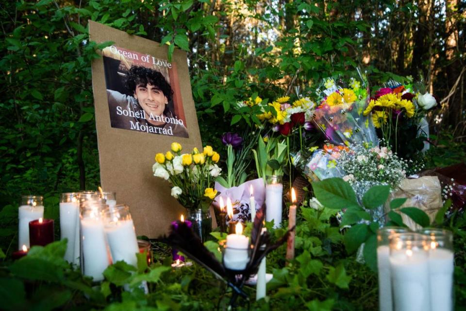 Candles burn at a makeshift memorial in a wooded area near a shopping center off New Bern Avenue in Raleigh following a vigil for Soheil Antonio Mojarrad, 30, of Raleigh Tuesday, April 23, 2019. Mojarrad was killed in an officer-involved shooting Saturday.