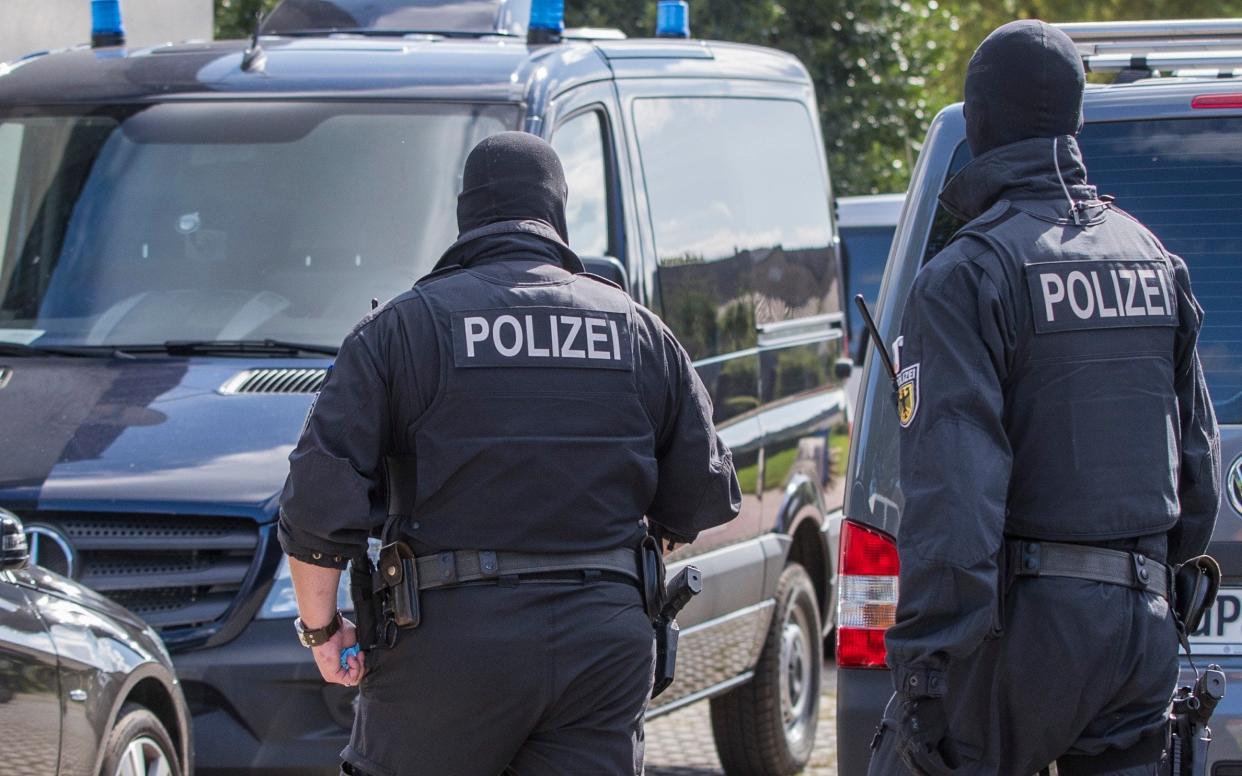 German prosecutors say authorities have raided the homes and workplaces of two people who are suspected of drawing up a