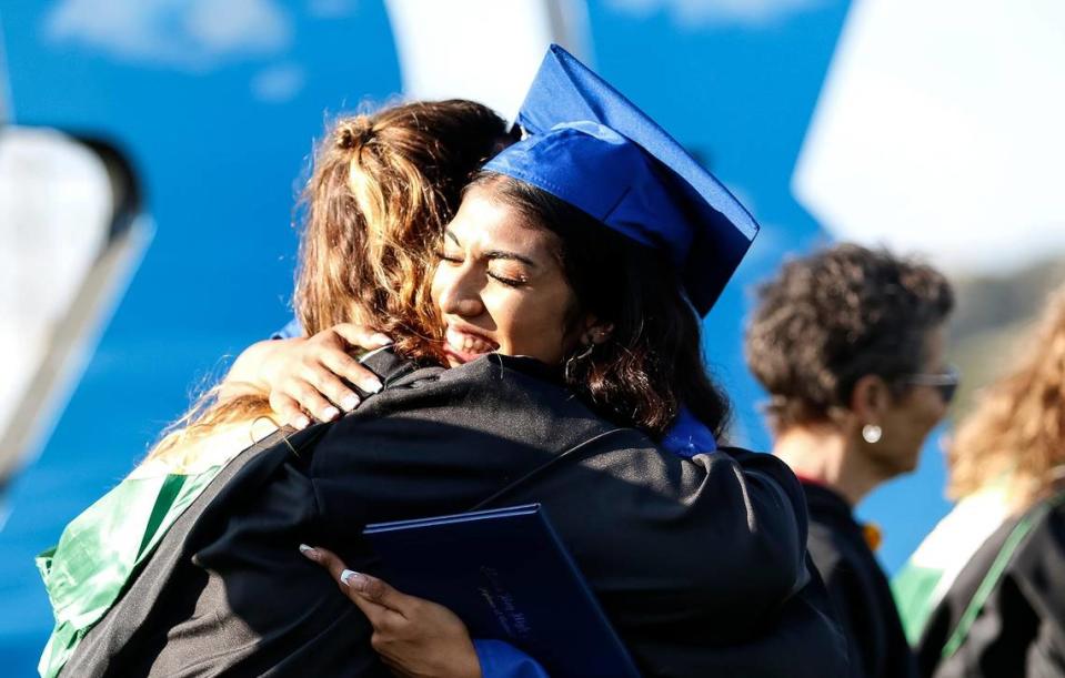 At Morro Bay High School, 180 grads were honored Thursday evening in a ceremony at the school’s football field. Graduating student Carmen Spahr tearfully hugs one of the teachers standing in line to congratulate the students.