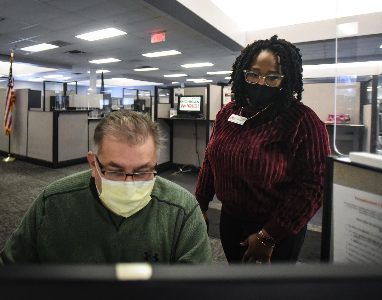 Capital Area Michigan Works! Employment Services Manager Genell Dorty, right, helps Lansing resident Art Gonzales submit electronic forms for unemployment benefits Wednesday, Jan. 12, 2022, at the CAMW! headquarters in Lansing. Gonzalez will return to his job of 13 years at an auto parts supplier on Jan. 24. He hasn't worked since December due to intermittent layoffs and a bout with COVID-19 that left him hospitalized.