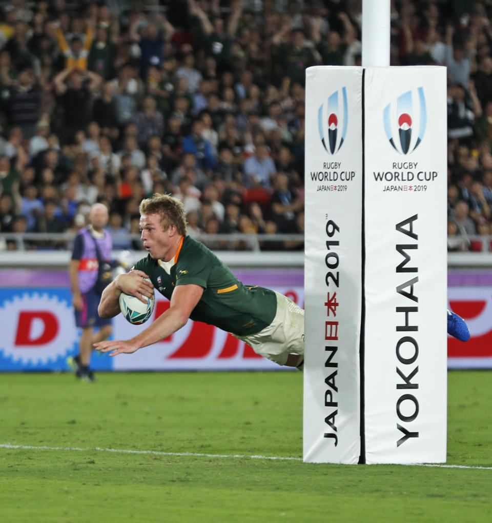 South Africa's Pieter-Steph du Toit leaps in the air to score a try during the Rugby World Cup Pool B game between New Zealand and South Africa in Yokohama, Japan, Saturday, Sept. 21, 2019. (AP Photo/Shuji Kajiyama)