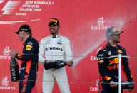 <p>Formula One F1 – Japanese Grand Prix 2017 – Suzuka Circuit, Japan – October 8, 2017. Mercedes’ Lewis Hamilton of Britain celebrates winning the race next to Bull’s Daniel Ricciardo of Australia and Max Verstappen of the Netherlands. REUTERS/Toru Hanai</p>