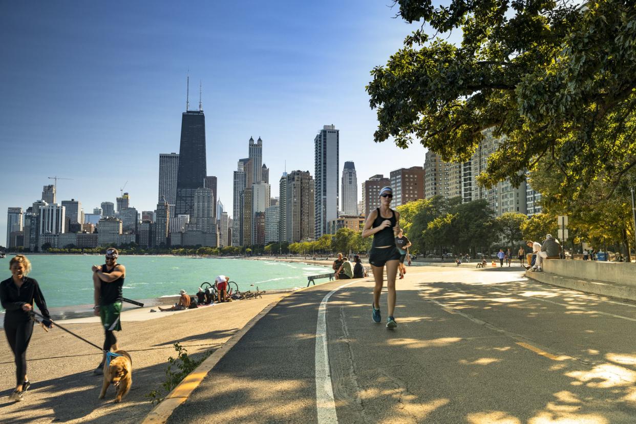 Chicago, Illinois, USA - September 25, 2018:  People walk and exercise along the Lakefront Trail on Lake Michigan and Lake Shore Drive in Chicago, Illinois USA.