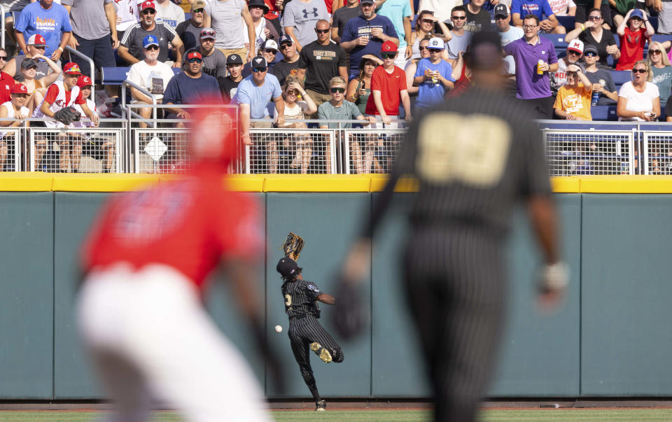 Vanderbilt's Javier Vaz (2) cannot reach a fly ball hit by Arizona's Branden Boissiere to left field to bat in two runners in the first inning during a baseball game in the College World Series, Saturday, June 19, 2021, at TD Ameritrade Park in Omaha, Neb. (AP Photo/Rebecca S. Gratz)