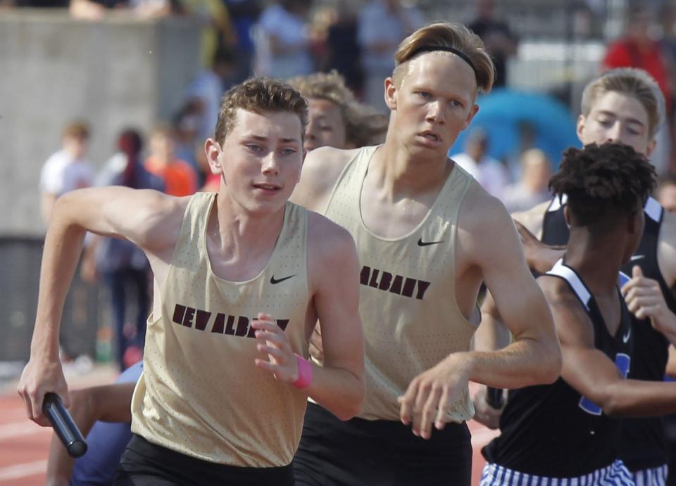 New Albany's Jack Fischer takes the baton from Eric Dehmer in the 3,200 relay at the Division I state meet June 3 at Ohio State. The Eagles finished ninth in 7:56.97.