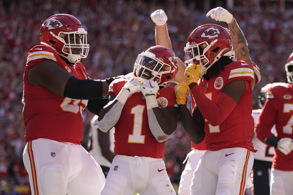 Kansas City Chiefs running back Jerick McKinnon (1) is congratulated by Trey Smith, left, and Rashee Rice, right, during the first half of an NFL football game against the Chicago Bears Sunday, Sept. 24, 2023, in Kansas City, Mo. (AP Photo/Charlie Riedel)