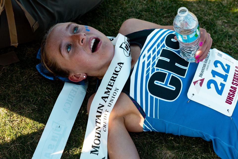 Carbon High School’s Rozlyn Stowe lays on the ground after her first-place finish in the 3A girls state high school cross-country championships at the Regional Athletic Complex in Salt Lake City on Tuesday, Oct. 24, 2023. | Megan Nielsen, Deseret News