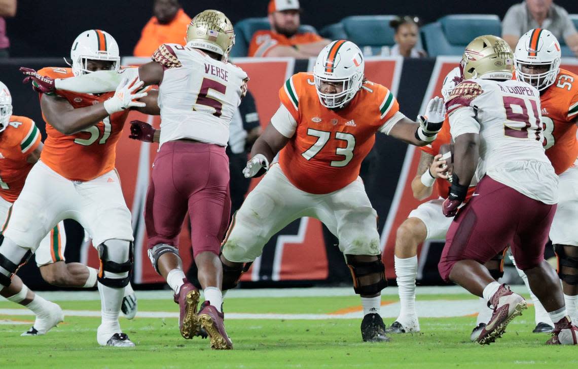 Miami Hurricanes offensive lineman Anez Cooper (73) sets up to block Florida State Seminoles defenders in the second quarter at Hard Rock Stadium in Miami Gardens on Saturday, November 5, 2022.