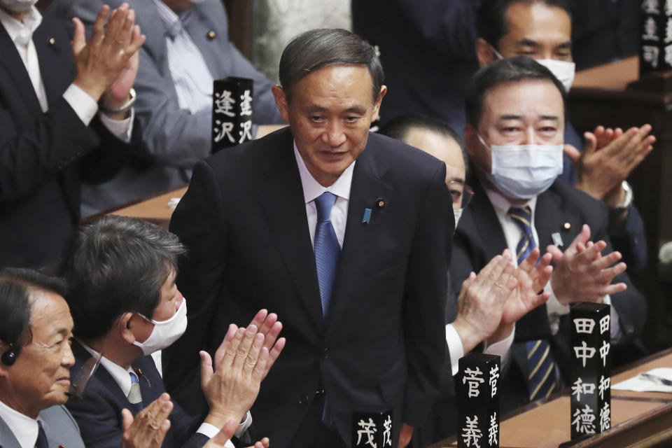 Yoshihide Suga is applauded after being elected as Japan's new prime minister at parliament's lower house in Tokyo, Wednesday, Sept. 16, 2020. Suga was formally elected Wednesday as Japan’s new prime minister in a parliamentary vote, replacing Shinzo Abe. (AP Photo/Koji Sasahara)