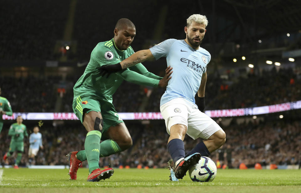 Watford's Christian Kabasele, left, and Manchester City's Sergio Aguero battle for the ball during the English Premier League soccer match between Manchester City and Watford at the Etihad Stadium, Manchester, England, Saturday March 9, 2019. (Martin Rickett/PA via AP)