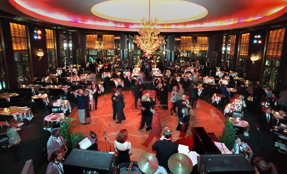 FILE - In this Dec. 17, 1998 file photo, guests at New York's Rainbow Room dance on the revolving floor of the restaurant and nightclub. Closed in 2009 amid a landlord-tenant dispute, the iconic club at Rockefeller Center will reopen in the fall of 2014. Tishman Speyer, which operates Rockefeller Center, made the reopening announcement on Tuesday, Sept. 17, 2013. (AP Photo/Suzanne Plunkett, File)