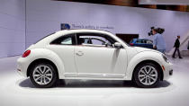 Volkswagen just unveiled the 2013 Volkswagen Beetle TDI, an oil-burning version of the recently revised and manliness-infused Beetle. America's only diesel two-door (VW considers this a coupe and the Golf a hatch) will go on sale this summer. The engine is VW's familiar 2.0 liter turbocharged and direct-injected 4-cylinder, now sporting a common-rail fuel injection setup and putting 140 horsepower and 238 lb/ft of torque into your choice of six-speed transmissions: either a traditional manual or the DSG semiautomatic. EPA fuel economy scores of 29 mpg city and 39 mpg highway have been confirmed.