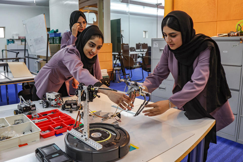 Raihana Sattari, from left, Marwa Shinwari and Heela Barakzai, members of an all-girl Afghan robotics team, assemble components in Qatar's capital Doha. (Karim Jaafar / AFP via Getty Images)
